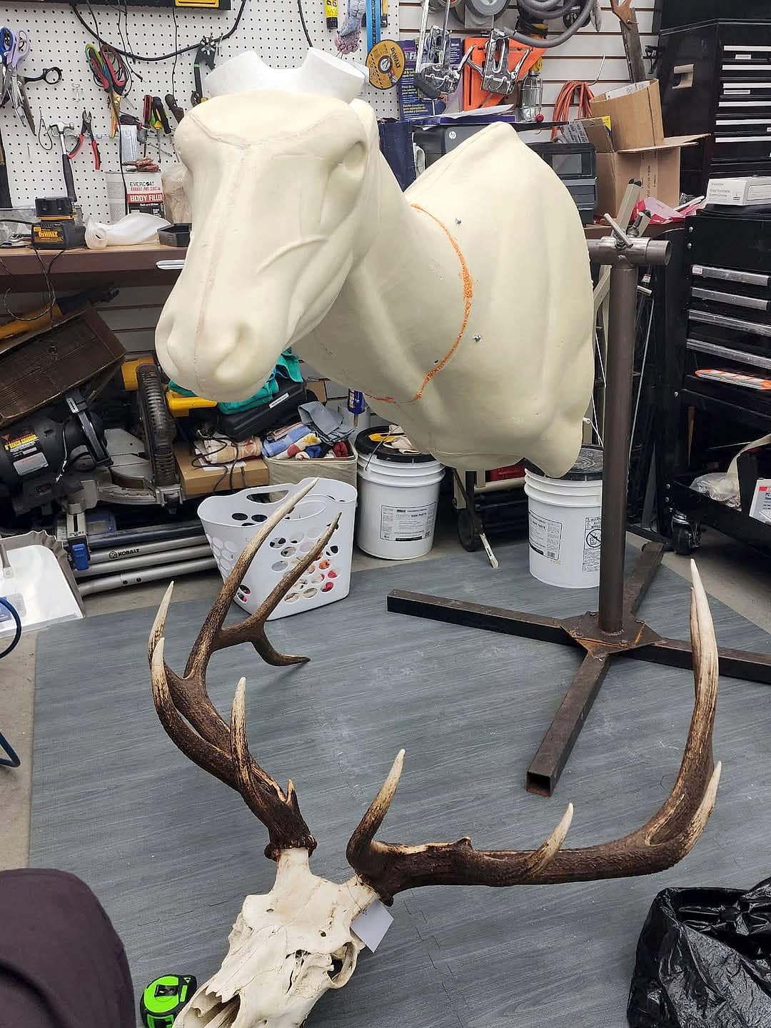 Custom metal stand holding a mount form in the shop